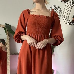Orange boho cottage core style dress. Puff sleeve with flare detail on wrist